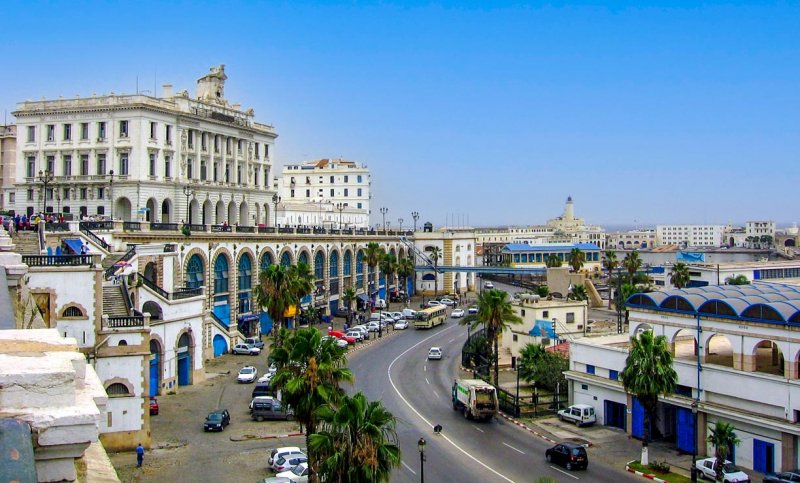 Algiers seafront boulevard with arcaded colonial buildings and the port beyond