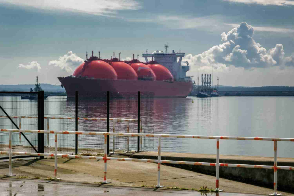 LNG tanker with red spherical tanks moored at a gas terminal