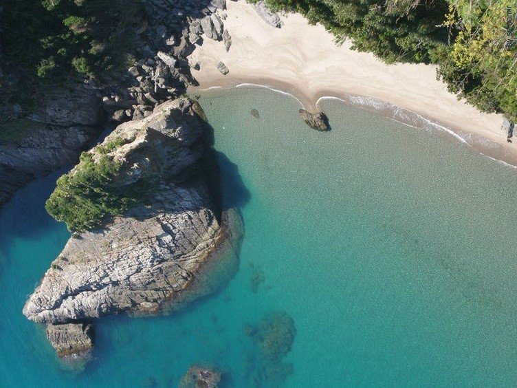 Aerial view of La Crique near Jijel, a sandy cove with turquoise water and forest