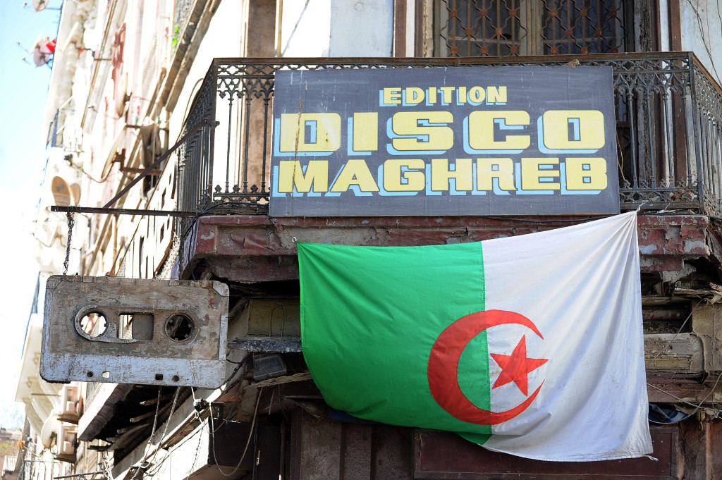 Disco Maghreb record shop sign in Oran with a giant cassette and an Algerian flag
