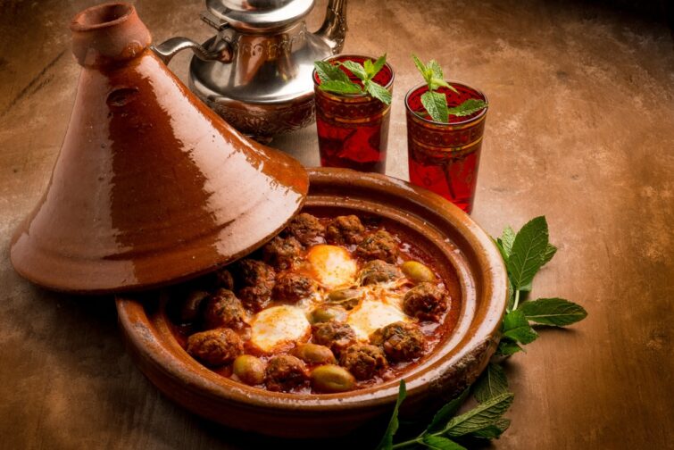 Meatball and egg tagine served with glasses of mint tea