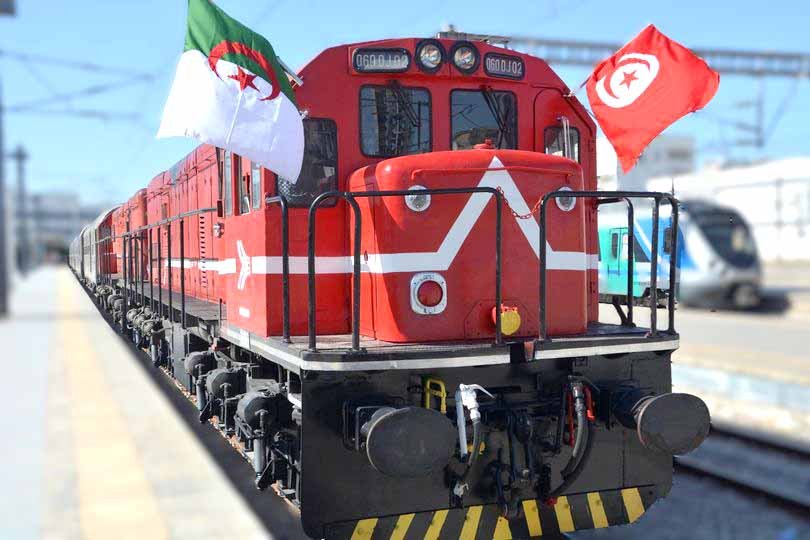 Red locomotive flying Algerian and Tunisian flags for the Tunis to Annaba train