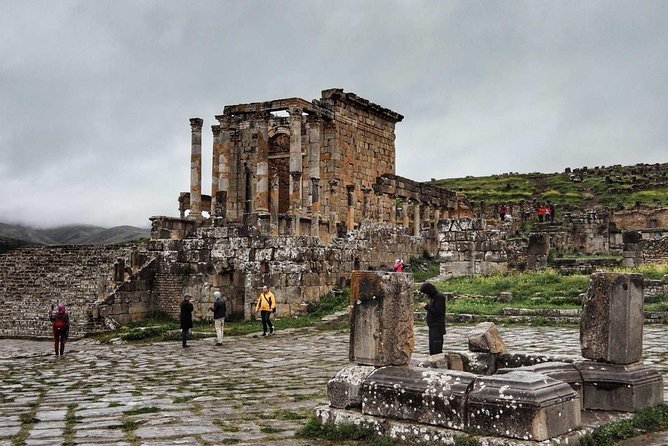 Visitors on the Roman paving of Djemila below the Temple of the Septimian Family