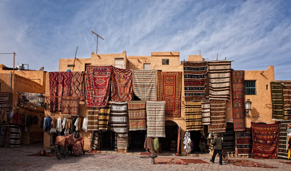 Woven carpets hanging on the arcaded houses of the Ghardaïa market square