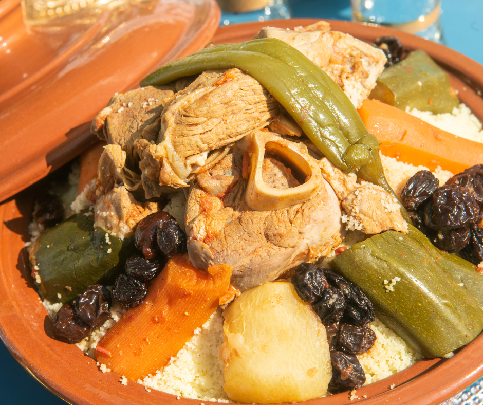 Lamb couscous with carrots, zucchini, chili pepper and raisins served in a tagine dish