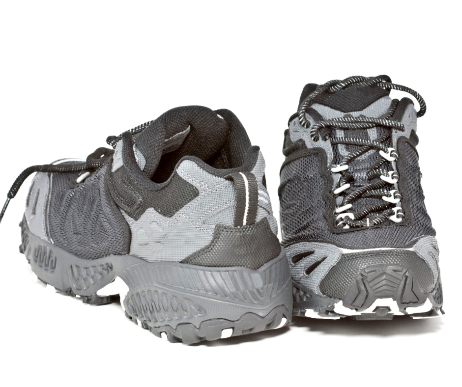 Pair of gray and black trail hiking shoes on a white background