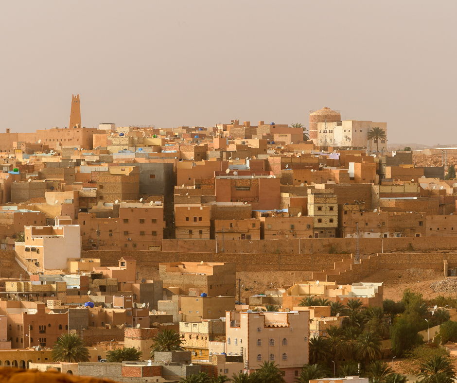 Sandstone houses of a M'Zab valley town with a minaret on the skyline