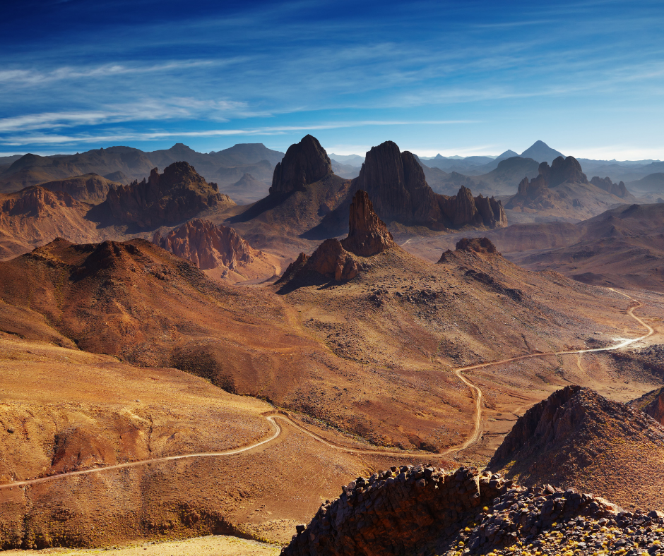 Volcanic peaks and winding tracks of the Hoggar mountains in the Algerian Sahara