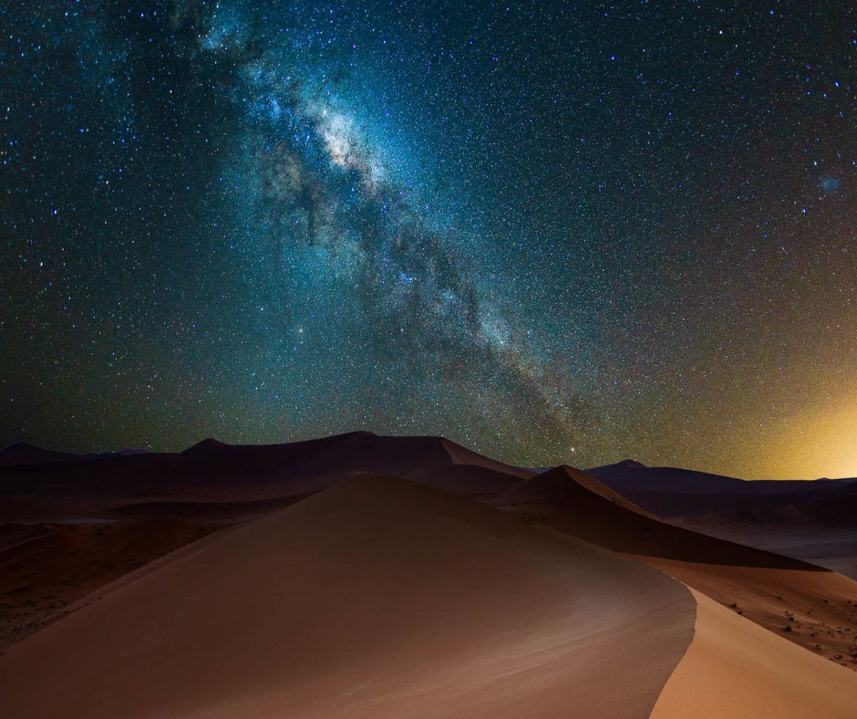 Milky Way over a dark dune and horizon at night