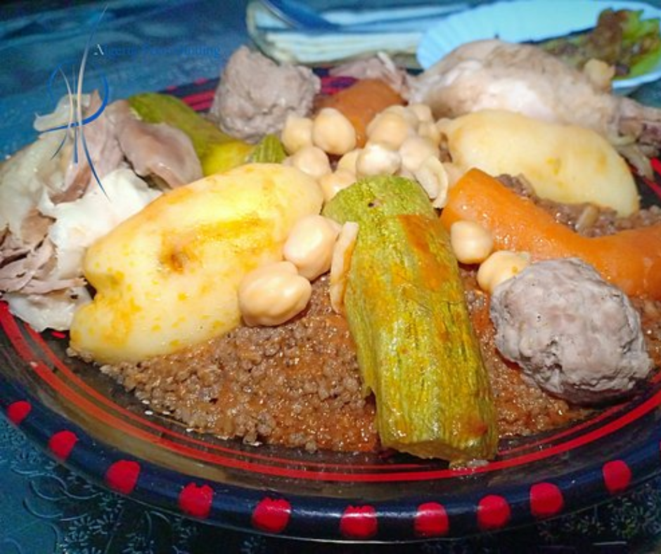 Couscous topped with chickpeas, carrot, zucchini, potato and a meatball