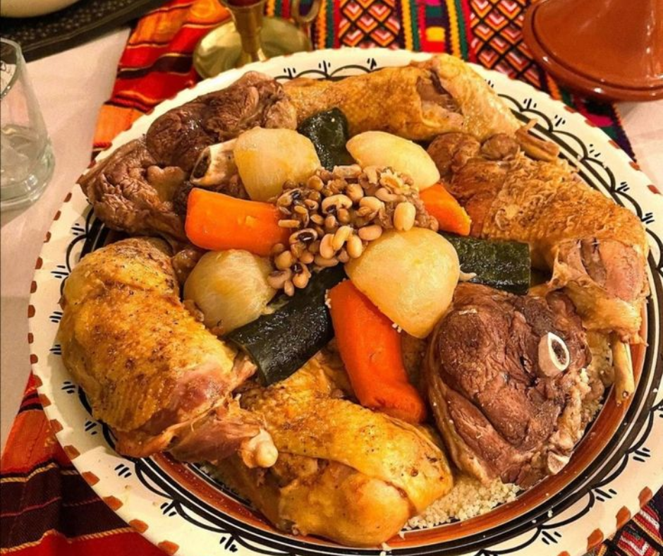 Platter of chicken, lamb, turnips, carrots and black-eyed peas on couscous