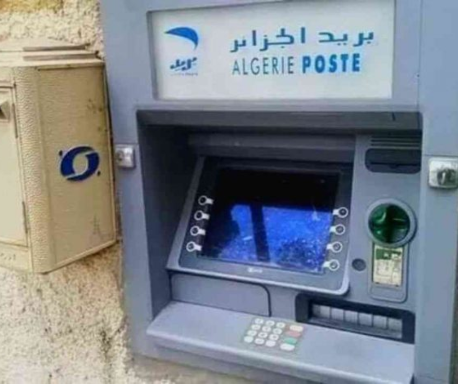 Algerie Poste cash machine with a cracked screen on a stone wall