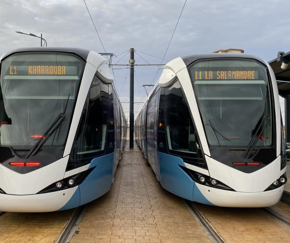 Two blue and white trams side by side marked Kharrouba and La Salamandre