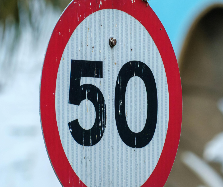 Round red-rimmed 50 km/h speed limit sign