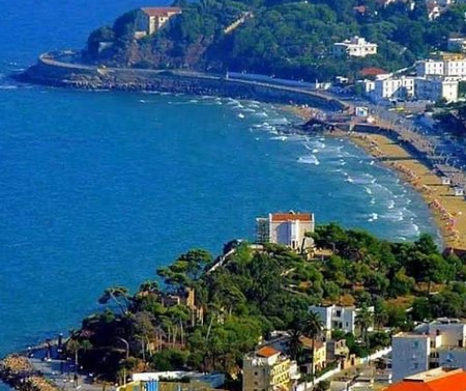 Curved sandy beach and blue bay along the Annaba Corniche