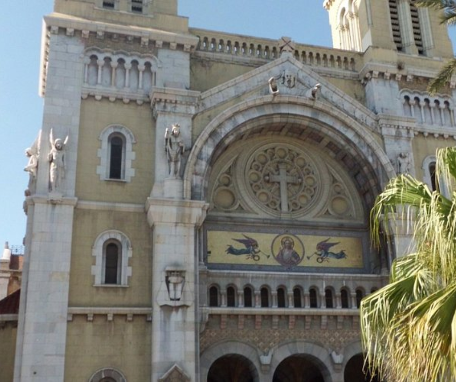 Facade of a cathedral with a mosaic of Christ and angel statues