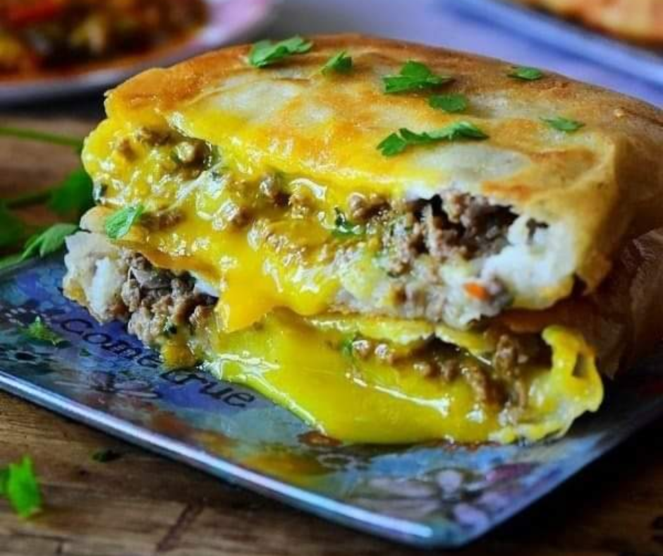 Fried bourek filled with minced meat, cheese and runny egg yolk