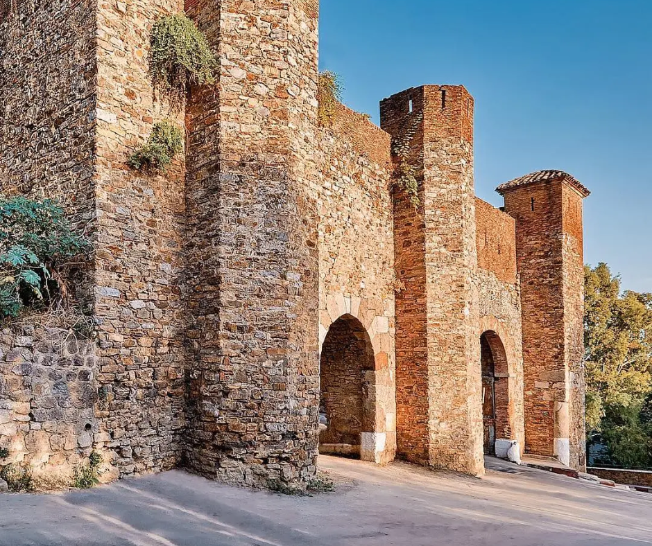 Brick and stone gate with arched openings at Bab el-Bahr in Béjaïa
