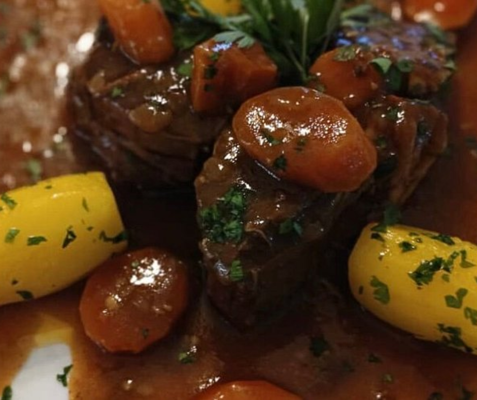 Braised beef with glazed carrots and yellow potatoes in sauce