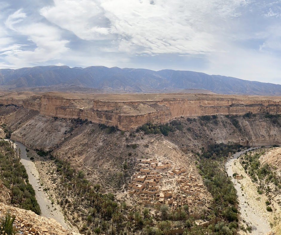 Ghoufi canyon with a cliff village and palm-lined riverbed in the Aurès