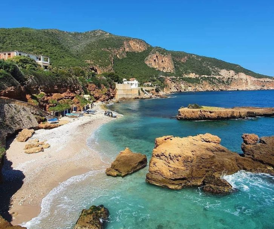 Turquoise cove with a pebble beach and rocky headlands on the Chenoua coast near Tipaza