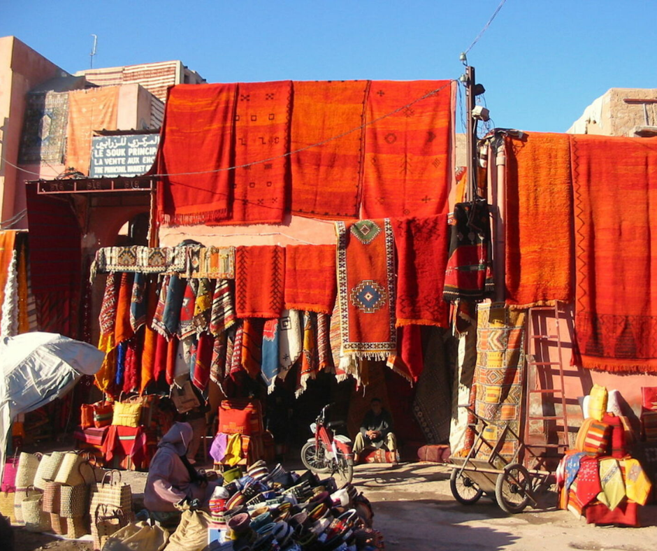 Colorful carpets and rugs hanging at an outdoor souk stall