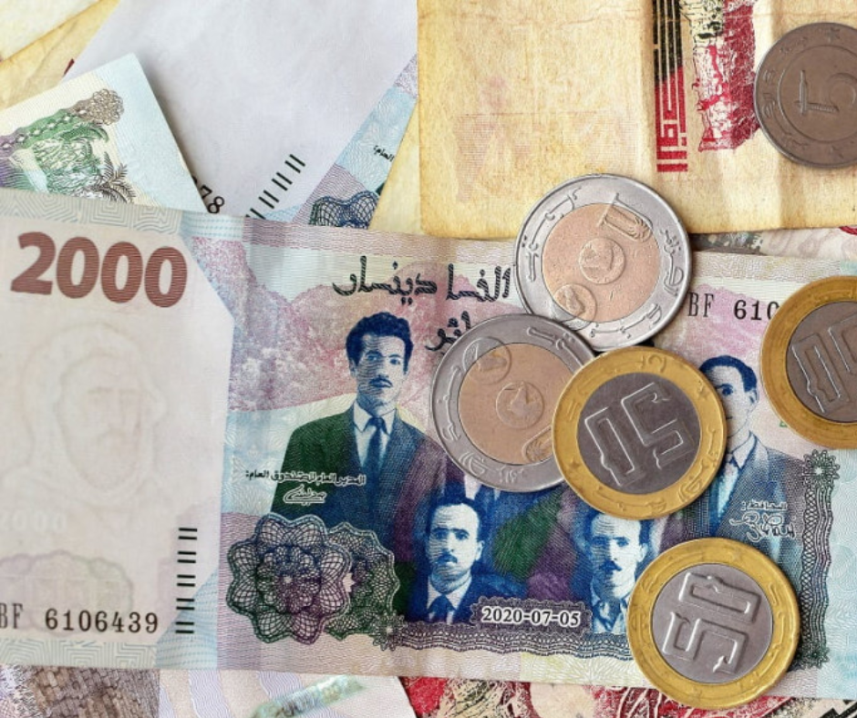 Algerian 2000 dinar banknote and dinar coins on a table