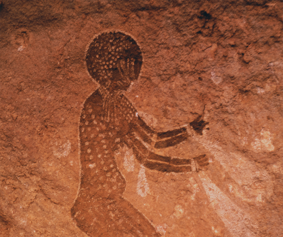 Rock painting of a figure with a dotted body in Tassili n'Ajjer