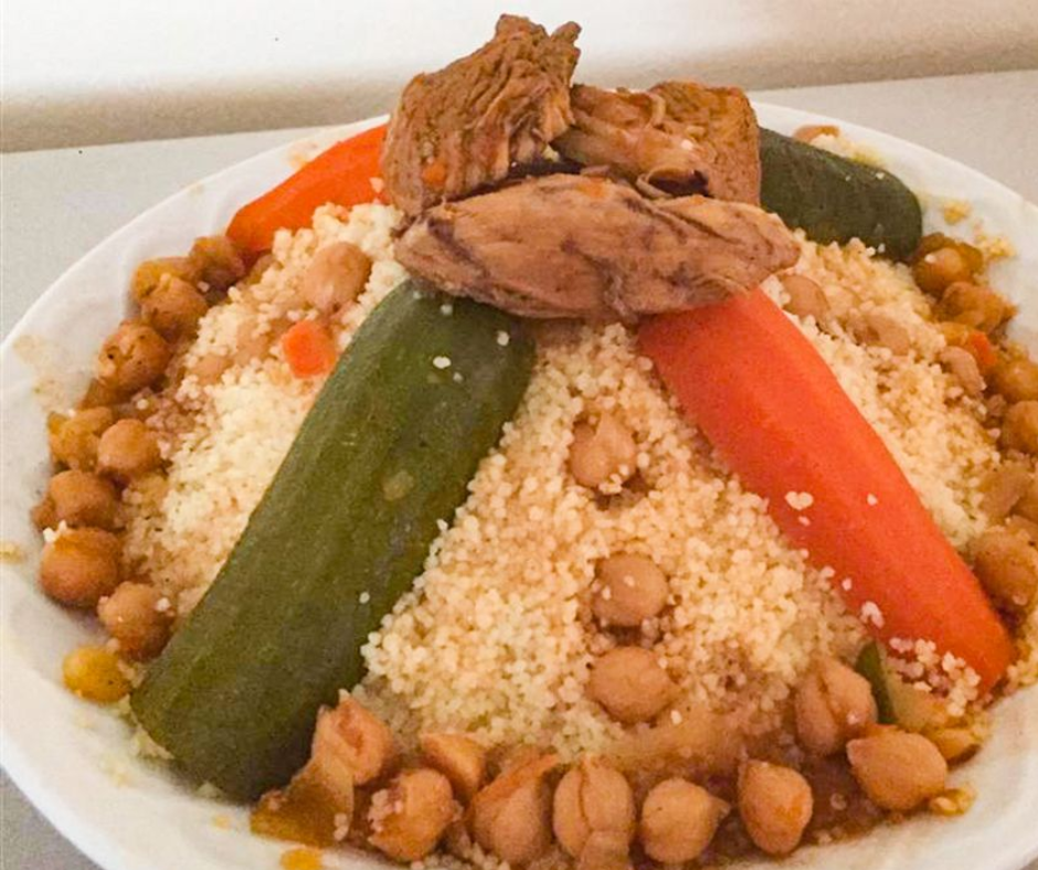 Plate of couscous with lamb, chickpeas, carrots and zucchini