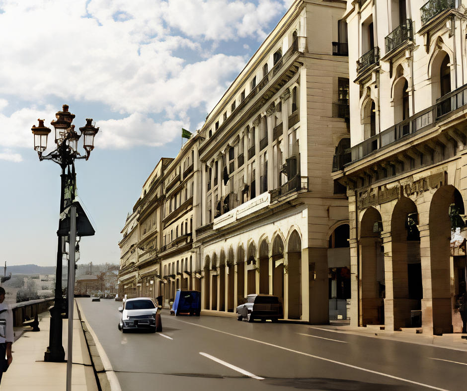 Arcaded buildings along the Algiers seafront boulevard with a street lamp