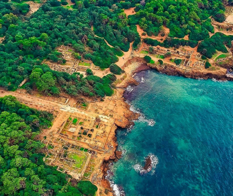 Aerial view of Roman ruins on the wooded Mediterranean shore at Tipaza