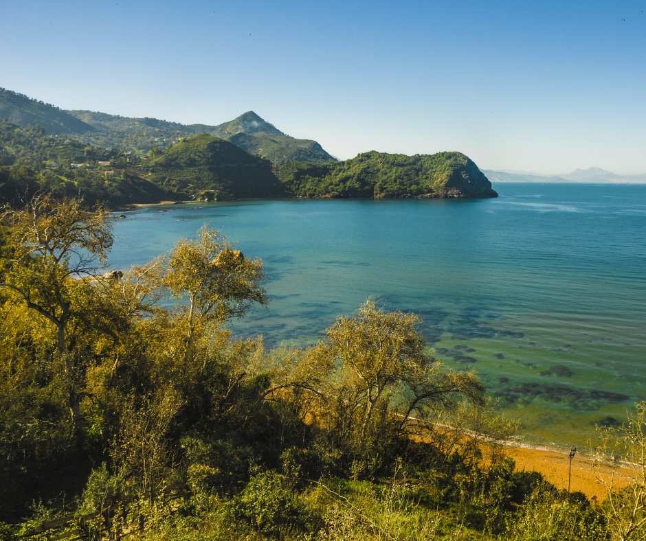 Green headland and a calm blue bay near Ziama Mansouriah
