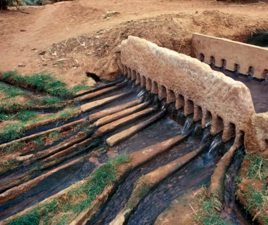 Foggara water divider with channels of flowing water at a Saharan oasis