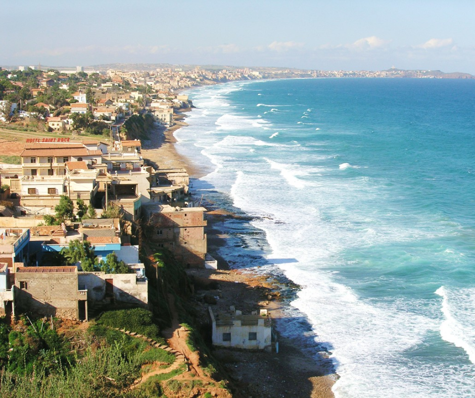 Coastal town and surf along the shoreline at Ain El Turk