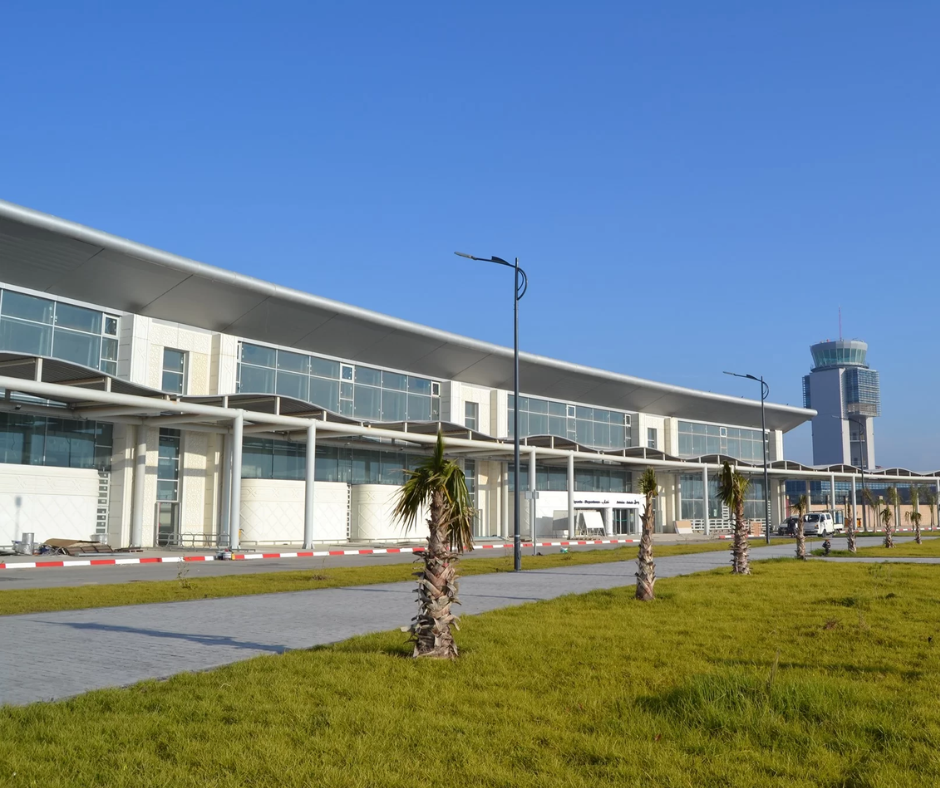 Modern airport terminal with glass facade and control tower at Oran