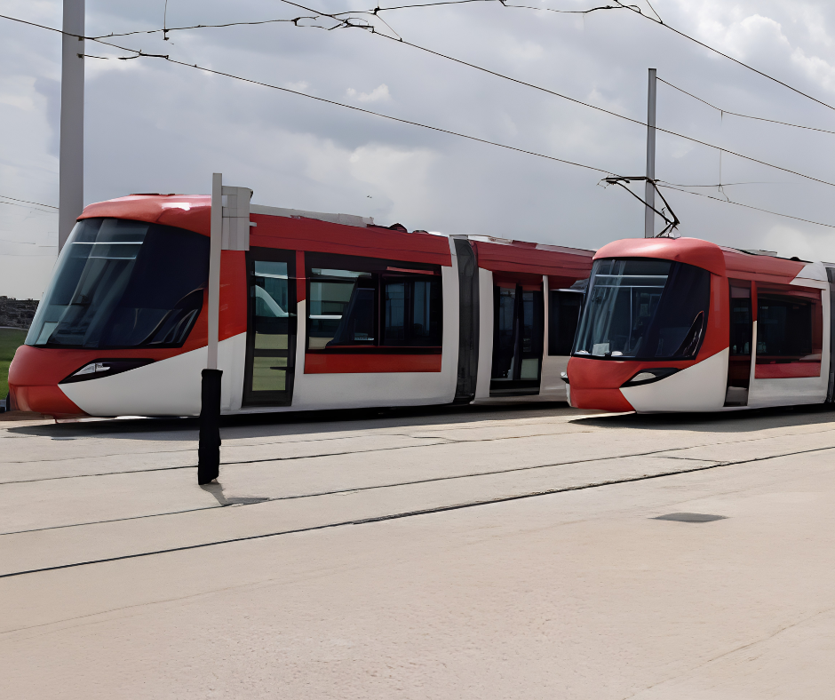 Red and white tram parked on tracks near Oran