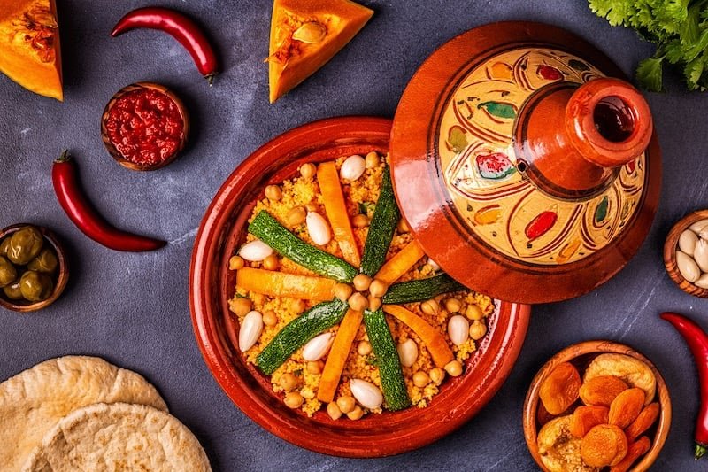 Vegetable couscous with carrots, zucchini and chickpeas in a painted tajine dish